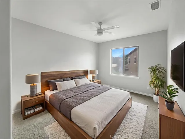 a bedroom with bed and a flat screen tv