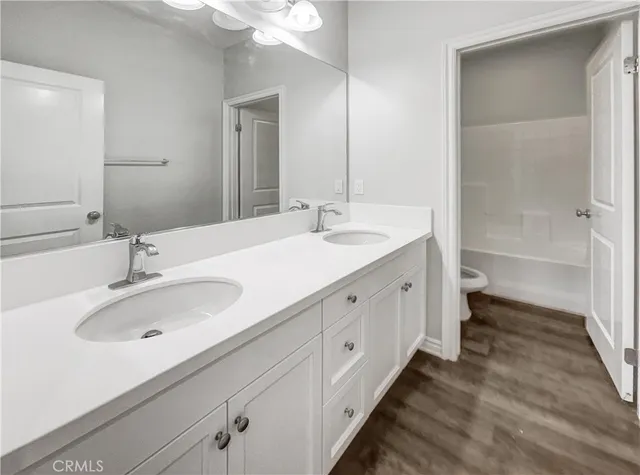 a bathroom with a double vanity sink and a mirror