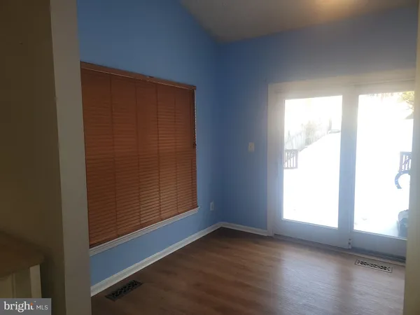 a view of a room with a window and a ceiling fan