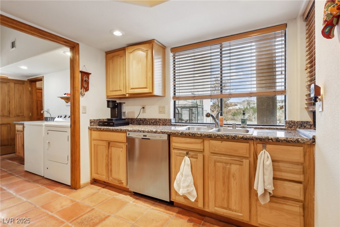 519 North Racetrack Road Henderson, NV 89015 - Photo 35 of 98 Kitchen featuring visible vents, light brown cabinetry, washing machine and dryer, a sink, and dishwasher