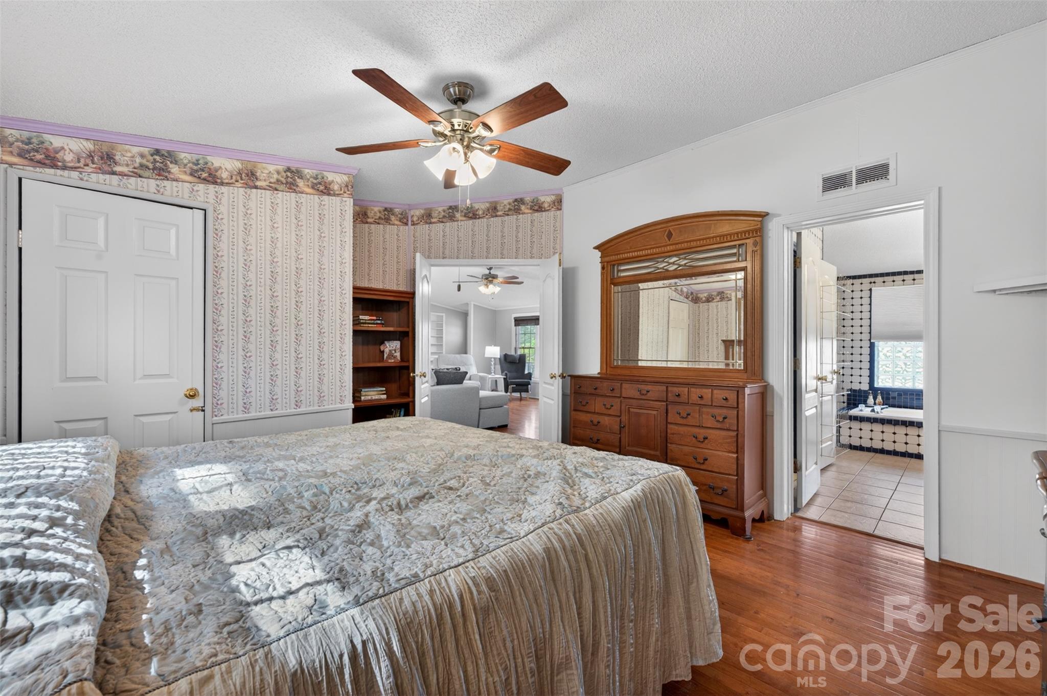 4352 Anderson Mountain Road Maiden, NC 28650 - Photo 18 of 42 a spacious bedroom with a large bed a chandelier and dresser
