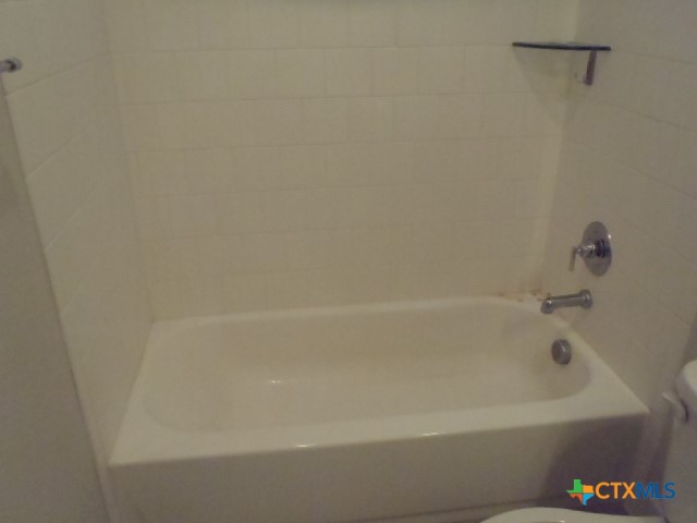 791 Hazy Hills Loop Dripping Springs, TX 78620 - Photo 41 of 44 a close up of a bathtub in a bathroom