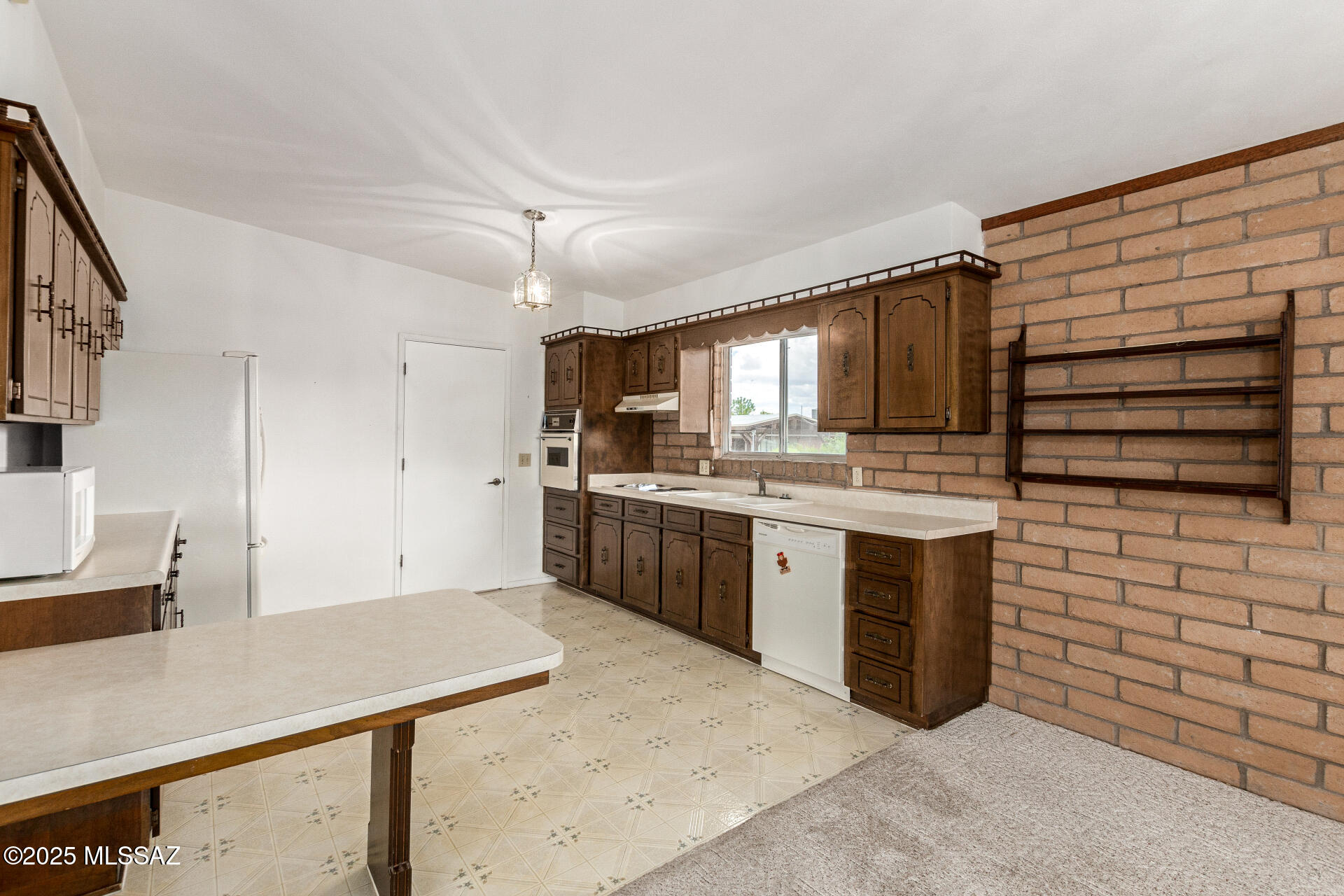 16381 South Observatory Place Vail, AZ 85641 - Photo 8 of 23 a kitchen with sink cabinets and window