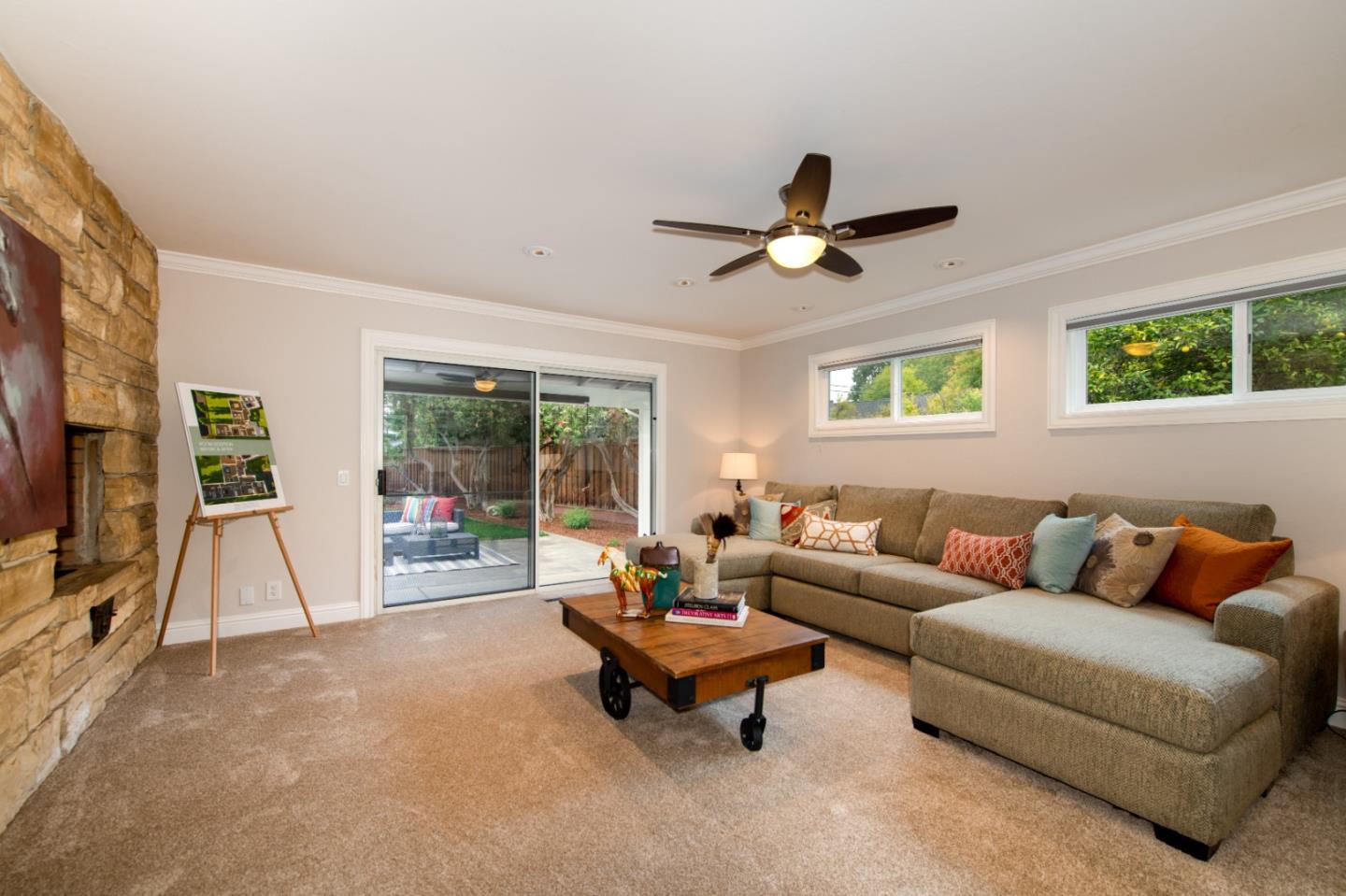 981 Thatcher Drive Los Altos, CA 94024 - Photo 12 of 30 a living room with furniture a ceiling fan and a flat screen tv
