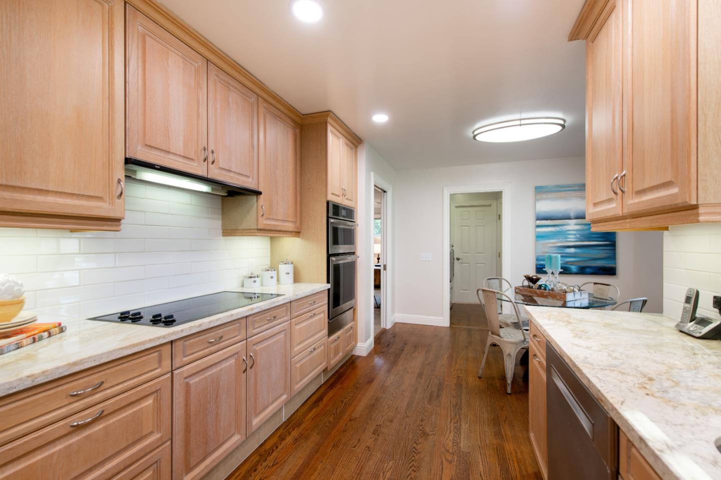 981 Thatcher Drive Los Altos, CA 94024 - Photo 14 of 30 a kitchen with a sink a stove cabinets and wooden floor