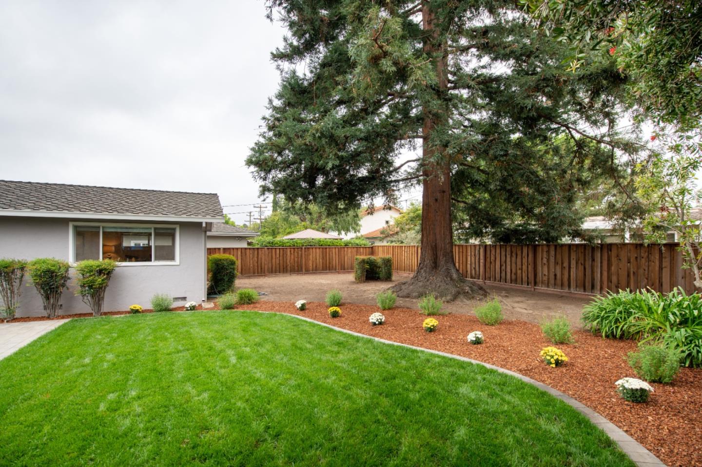 981 Thatcher Drive Los Altos, CA 94024 - Photo 25 of 30 a backyard of a house with table and chairs