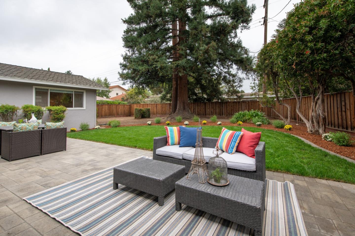 981 Thatcher Drive Los Altos, CA 94024 - Photo 27 of 30 a view of a patio with couches table and chairs with wooden fence and floor