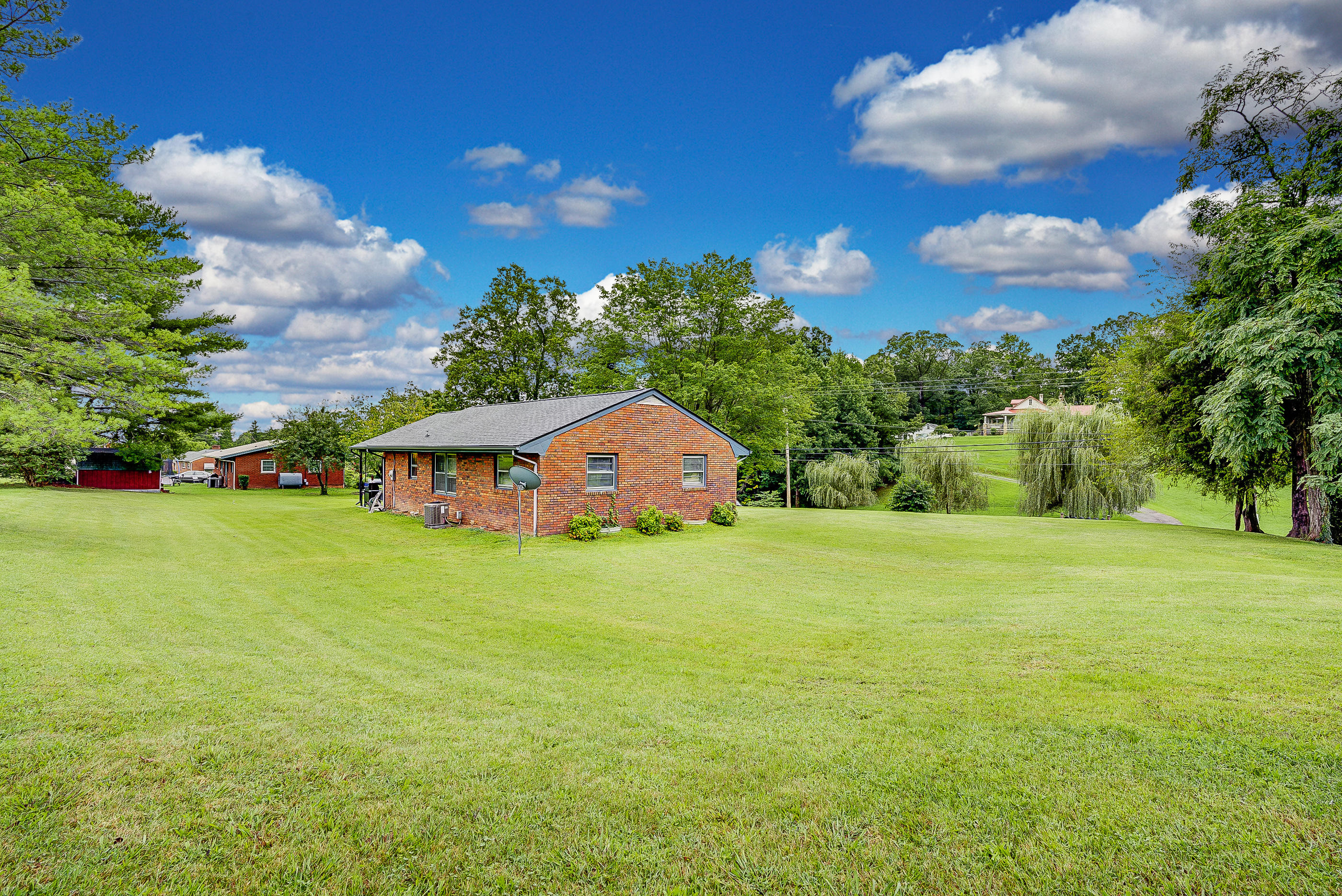 6147 Cove Road Roanoke, VA 24019 - Photo 2 of 16 a view of a large garden with plants and large trees
