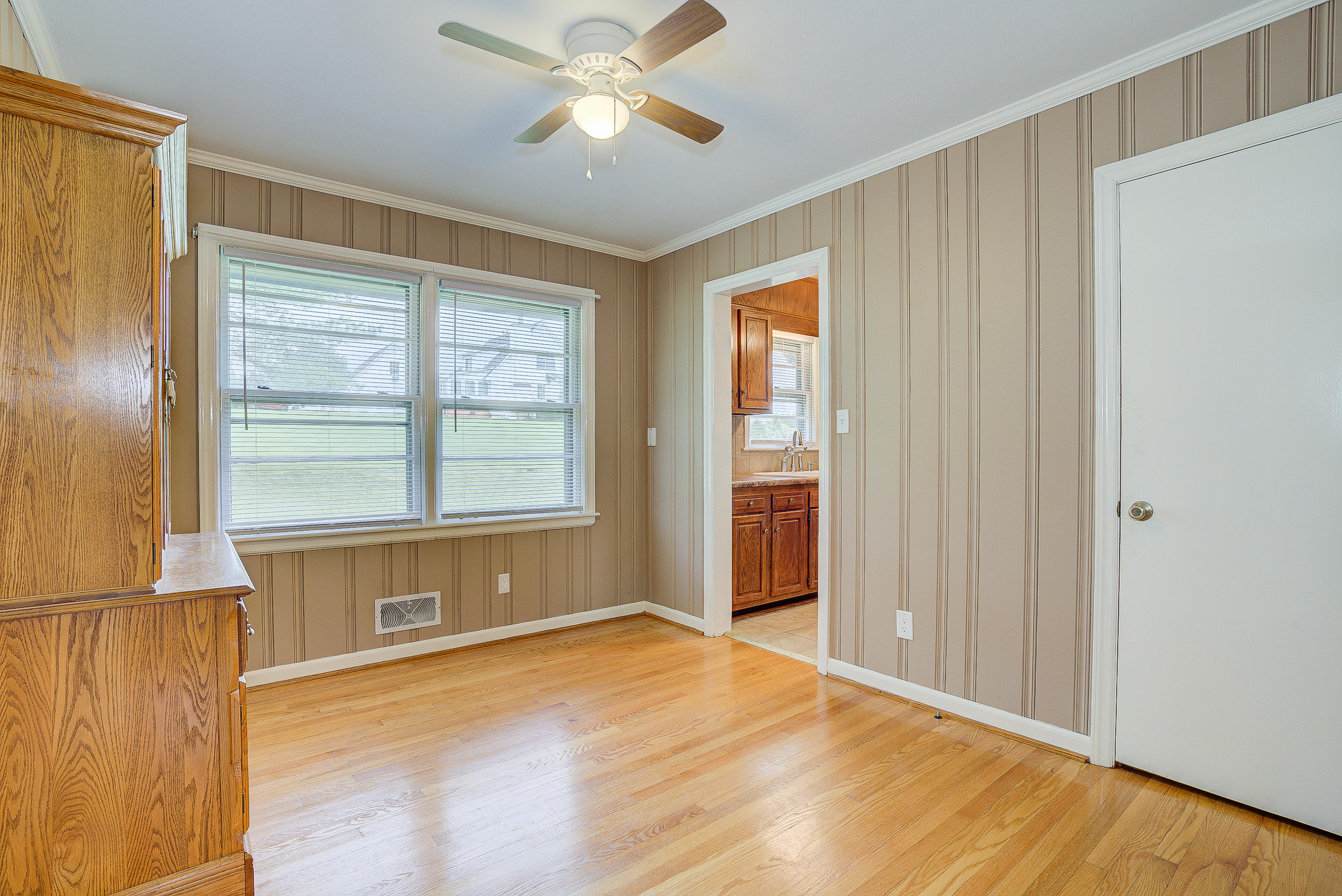 6147 Cove Road Roanoke, VA 24019 - Photo 11 of 16 a view of an empty room with a window and wooden floor