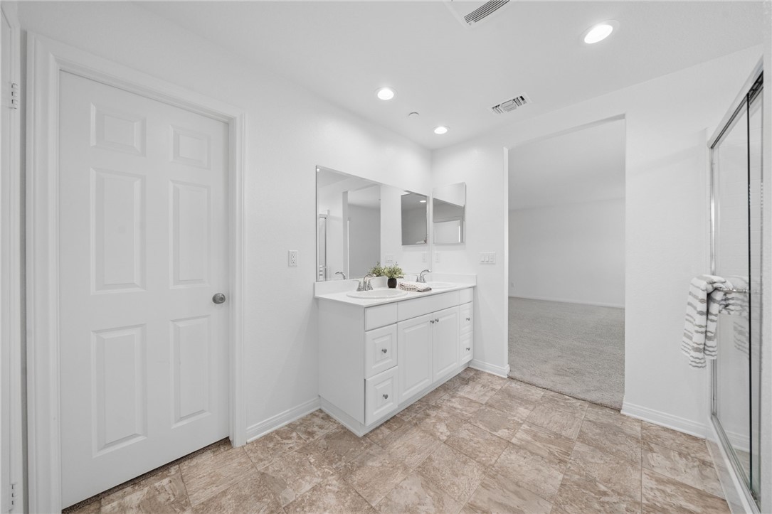 20130 Curaco Court Riverside, CA 92507 - Photo 27 of 43 Primary bathroom vanity with direct access to the bedroom.