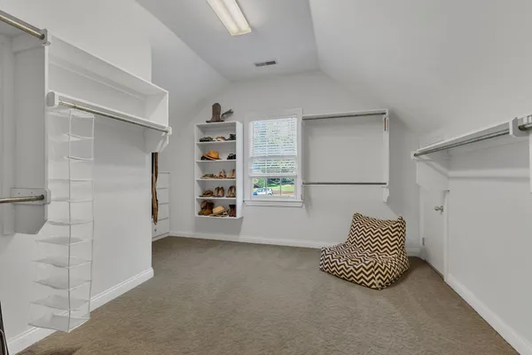 a living room with furniture and large windows