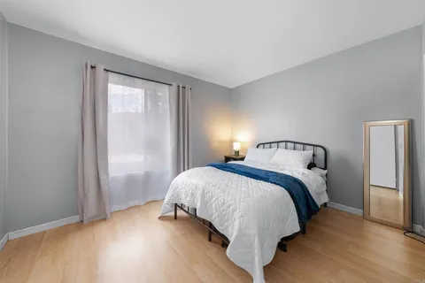 a bedroom with a bed and a mirror