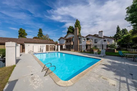 a view of house with outdoor space and sitting area