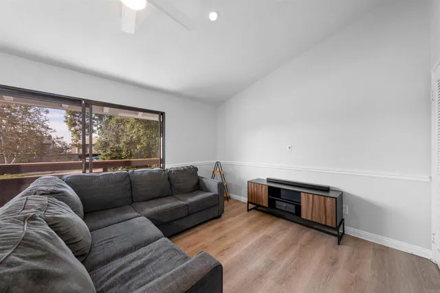 a living room with furniture window and a wooden floor