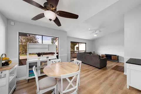 a living room with furniture a flat screen tv and a large window