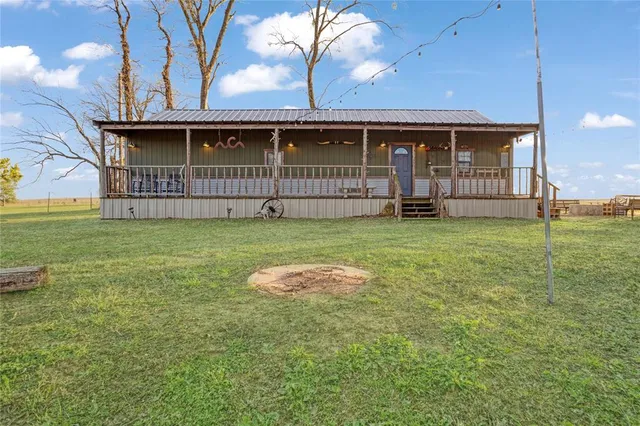 a view of a house with a yard and deck