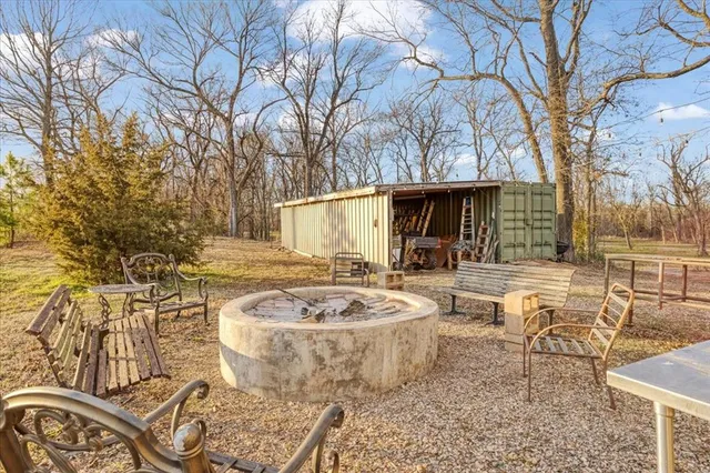 a view of a swimming pool with outdoor seating and plants