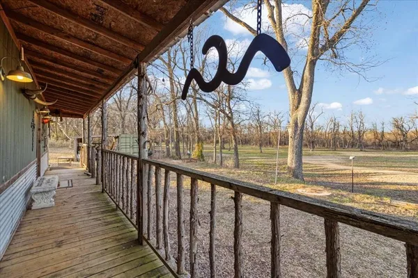 a view of a porch with a table and chairs