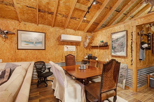 a view of a dining room with furniture and chandelier