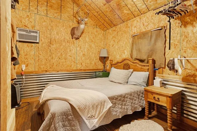 a bedroom with a bed and a curtain