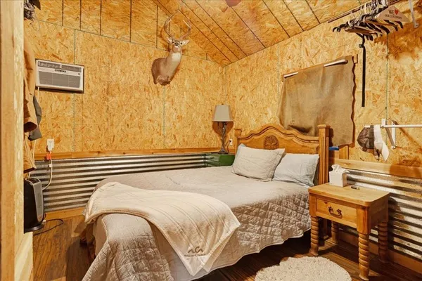 a bedroom with a bed and a curtain