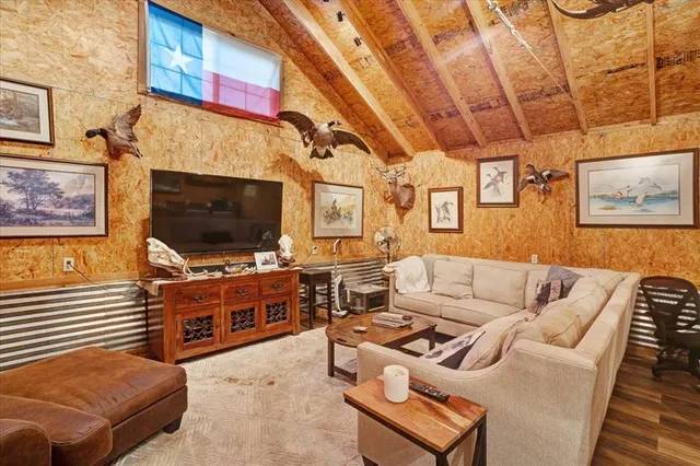 a living room with furniture and a chandelier
