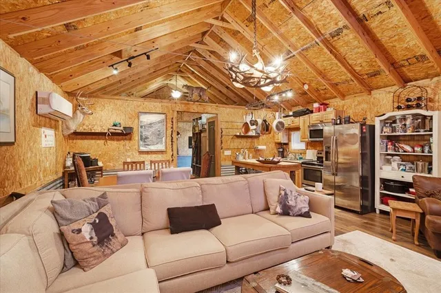 a view of a dining room with furniture and chandelier