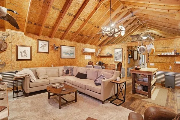 a living room with furniture and a chandelier