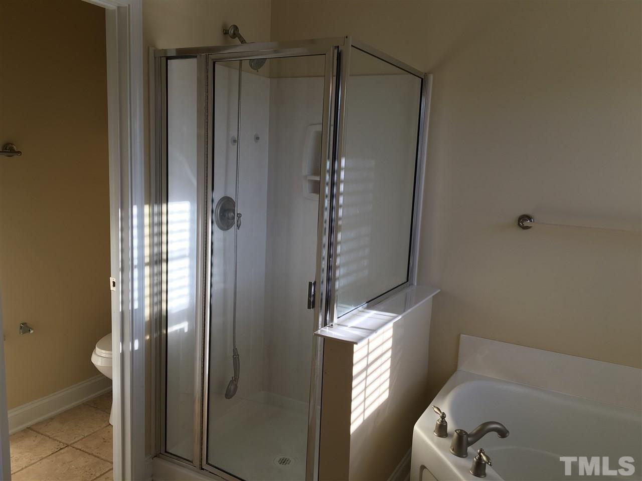 12223 Fox Valley Street Raleigh, NC 27614 - Photo 14 of 25 a bathroom with a shower and a tub