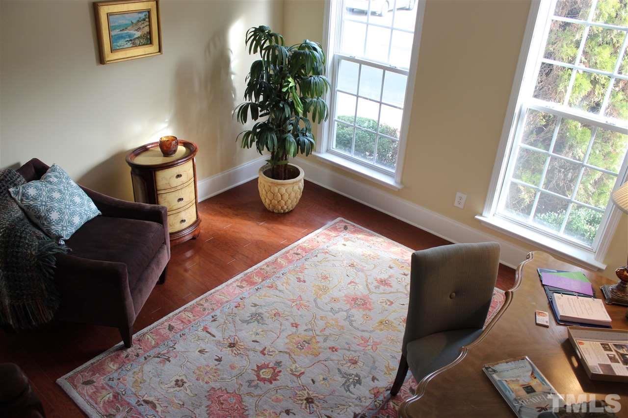 12223 Fox Valley Street Raleigh, NC 27614 - Photo 3 of 25 a living room with furniture and a potted plant