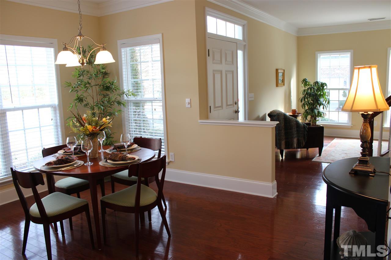 12223 Fox Valley Street Raleigh, NC 27614 - Photo 4 of 25 a view of a dining room with furniture and wooden floor