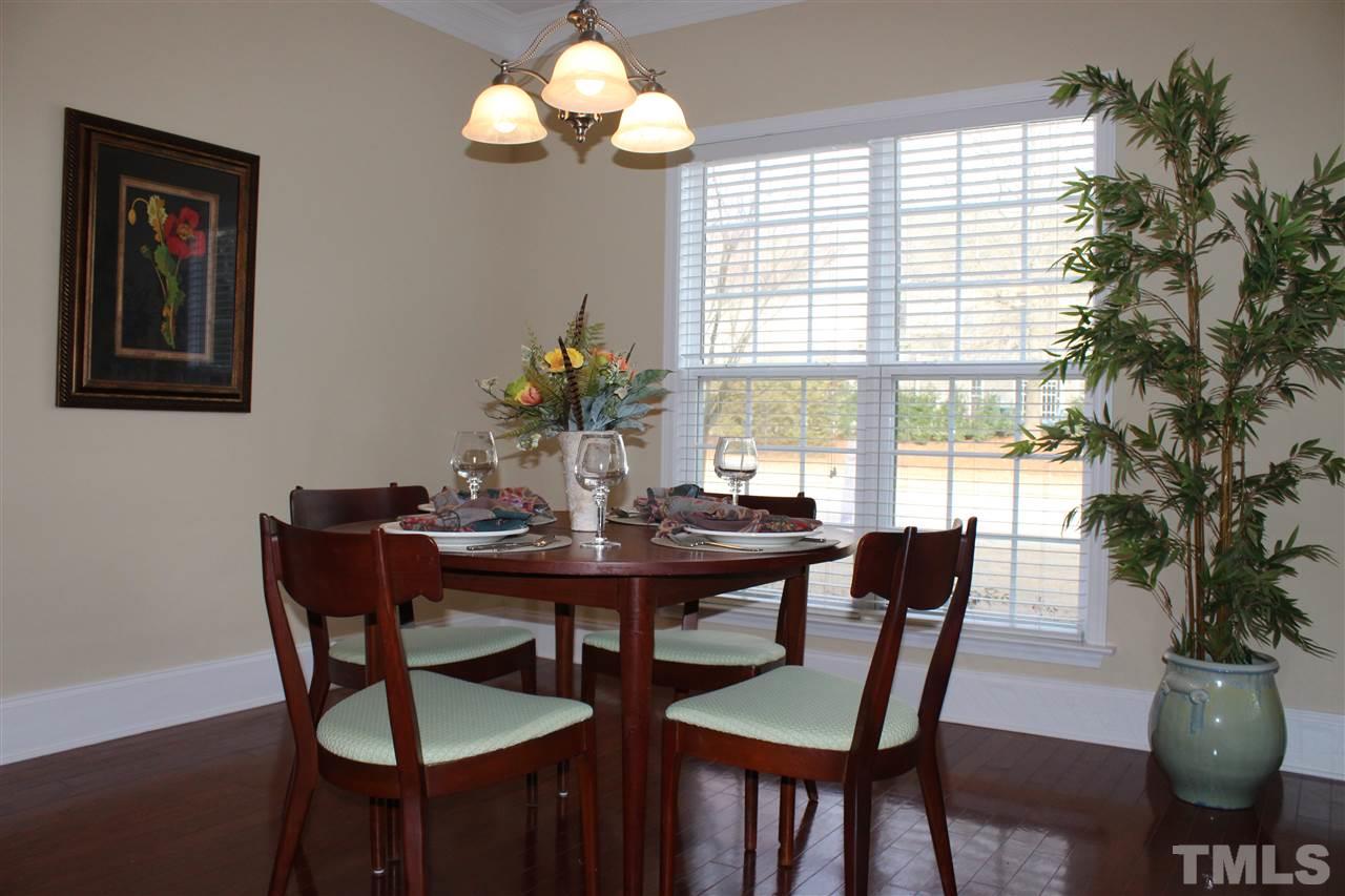 12223 Fox Valley Street Raleigh, NC 27614 - Photo 5 of 25 a view of a dining room with furniture window and wooden floor