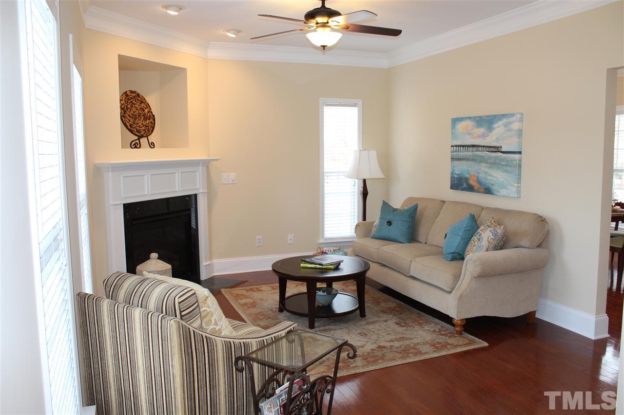 12223 Fox Valley Street Raleigh, NC 27614 - Photo 6 of 25 a living room with furniture and a fireplace