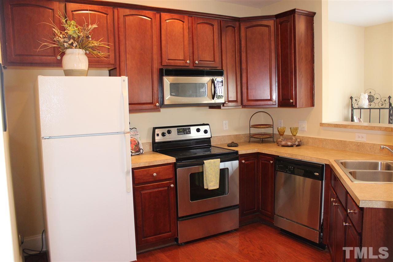 12223 Fox Valley Street Raleigh, NC 27614 - Photo 7 of 25 a kitchen with stainless steel appliances granite countertop a refrigerator a stove a sink and a microwave