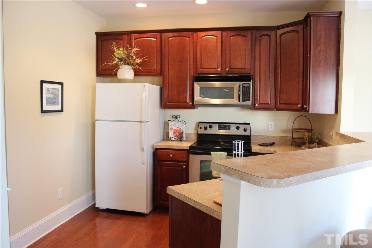 12223 Fox Valley Street Raleigh, NC 27614 - Photo 8 of 25 a kitchen with a refrigerator stove and microwave