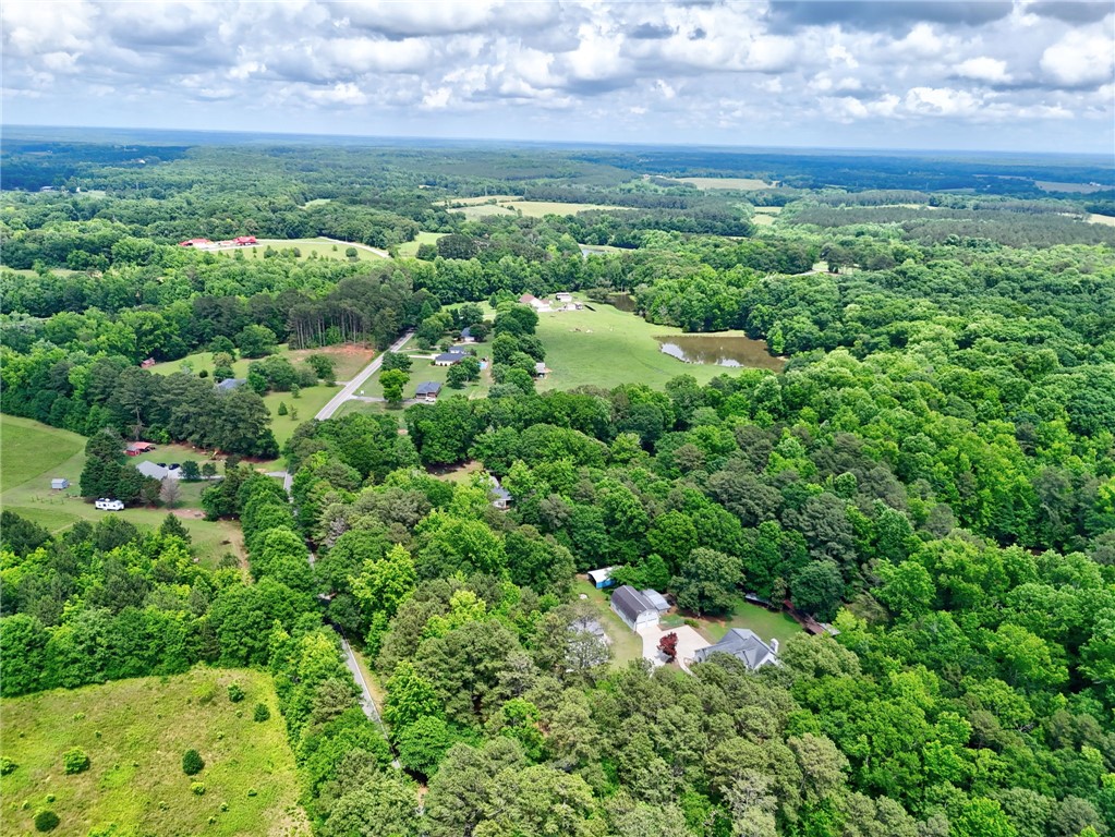 1016 Campbell Road Belton, SC 29627 - Photo 42 of 50 Vast green landscape dotted with homes and a tranquil pond, offering serene living.