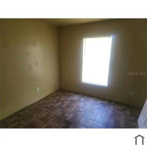 a room with a window and a projector screen