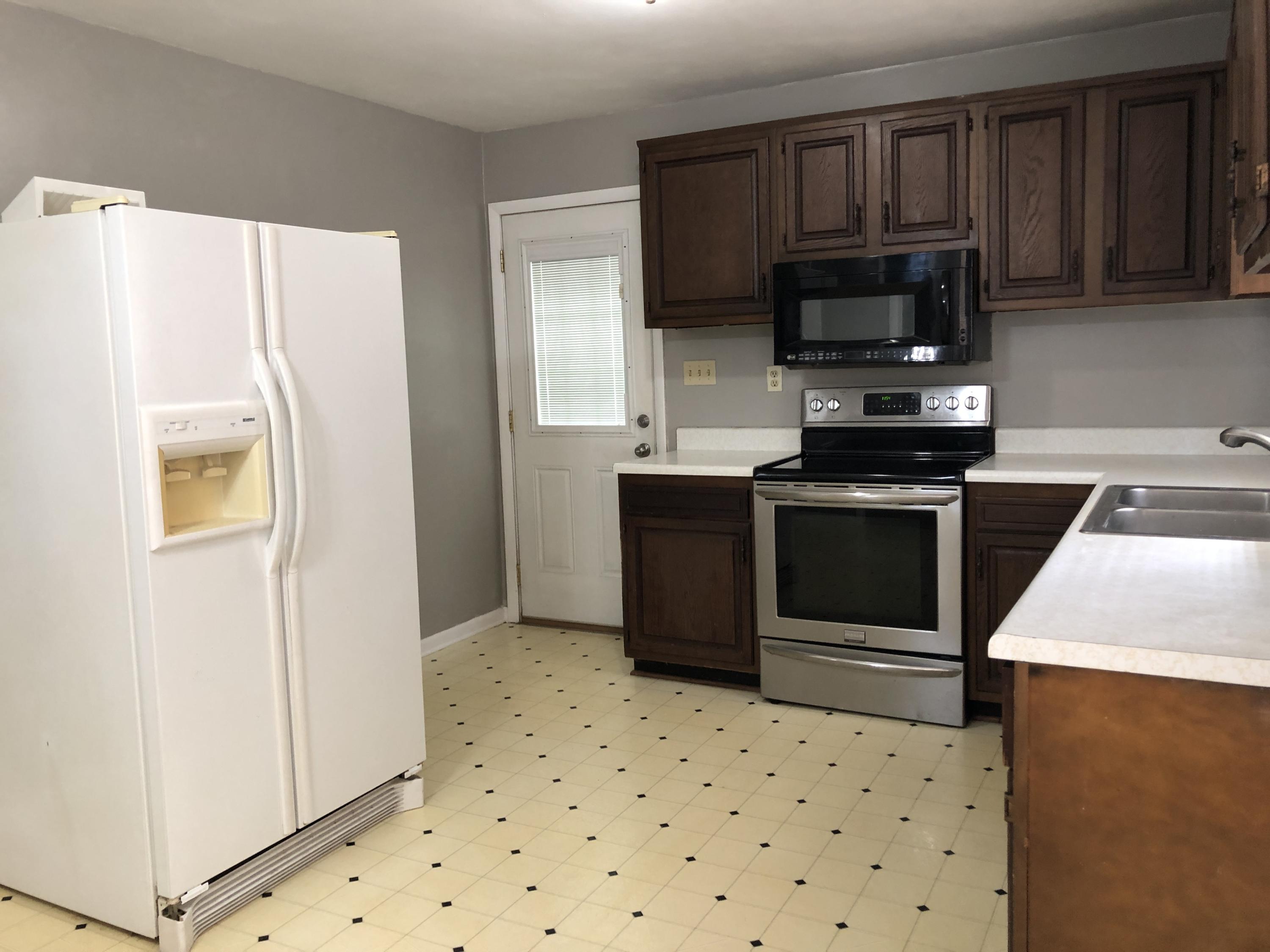 1325 Iron Ridge Road Rocky Mount, VA 24151 - Photo 8 of 17 a kitchen with stainless steel appliances a stove a microwave and a refrigerator
