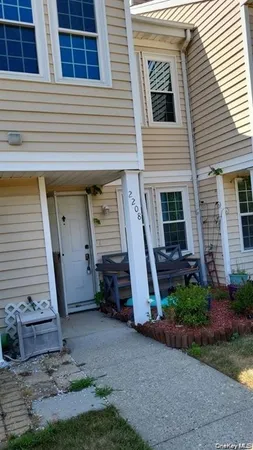 a view of a house with backyard and porch