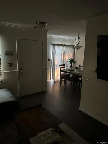 a kitchen with a table chairs and a refrigerator