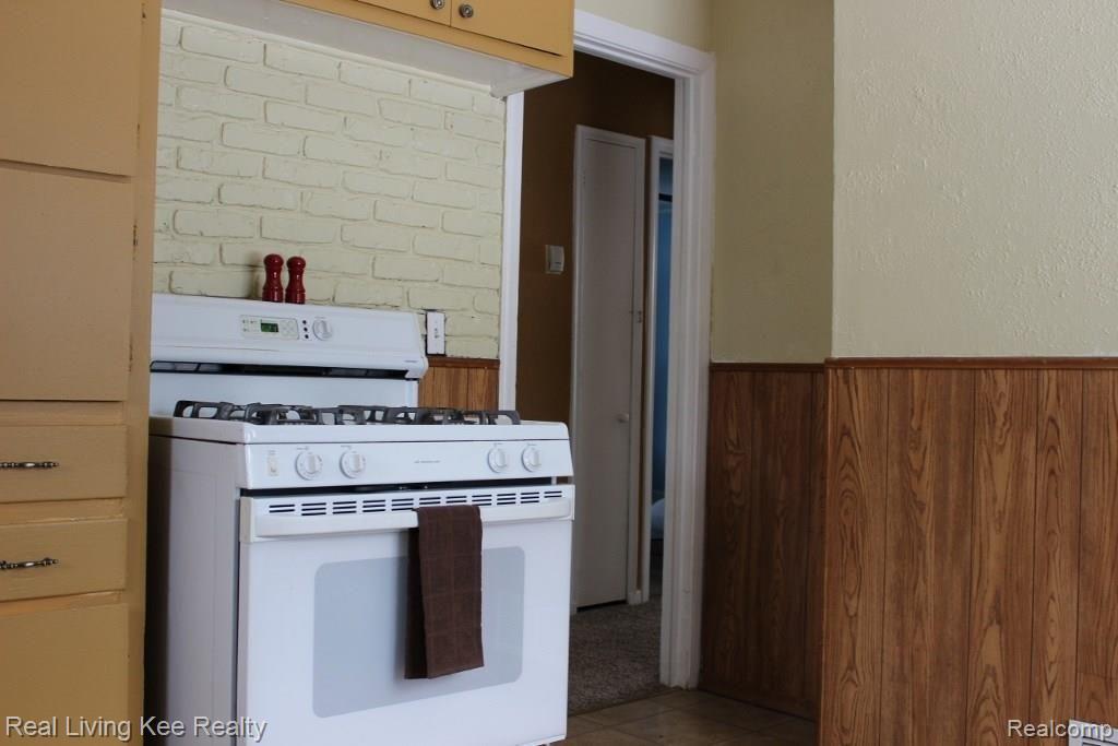 3512 Normandy Road Royal Oak, MI 48073 - Photo 7 of 18 Exposed brick and great storage make this kitchen a great space to cook!