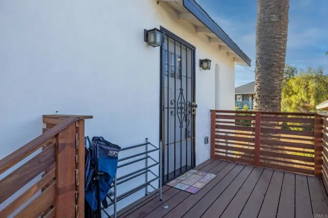 a view of a balcony with wooden floor and stairs