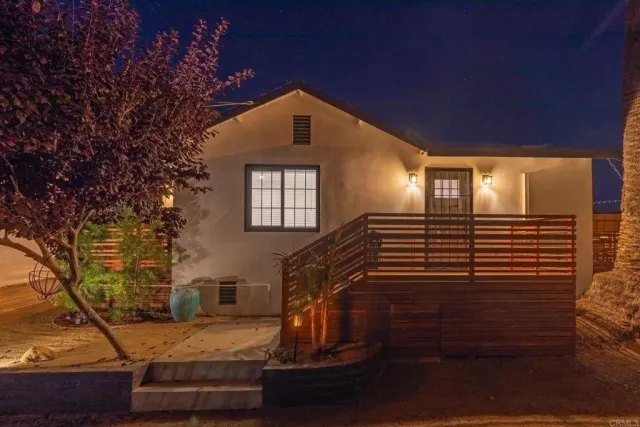 an aerial view of swimming pool patio and mountain view in back