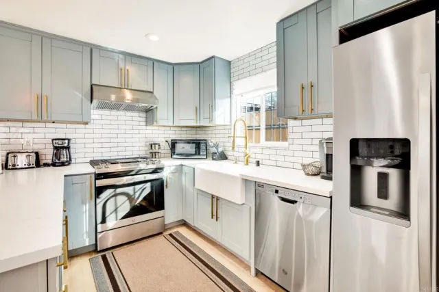 a kitchen with stainless steel appliances a stove sink and cabinets