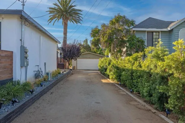 a couple of flower plants in front of house
