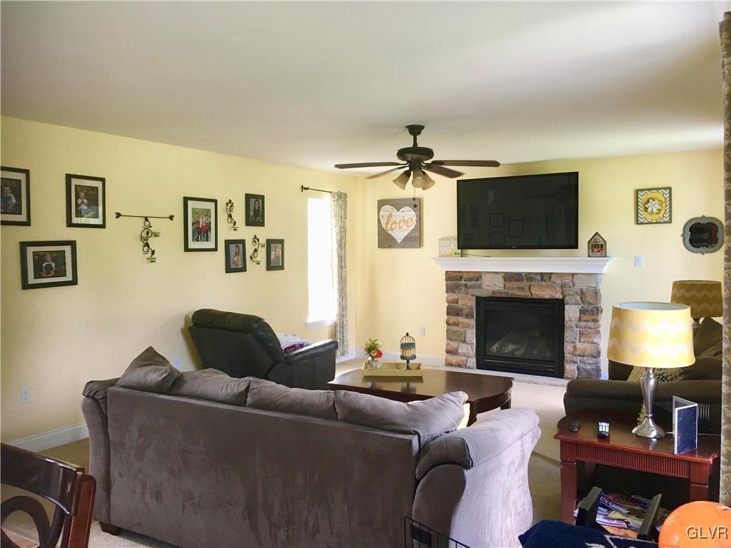 146 Fox Ridge Nazareth, PA 18064 - Photo 11 of 24 a living room with furniture a flat screen tv and a fireplace