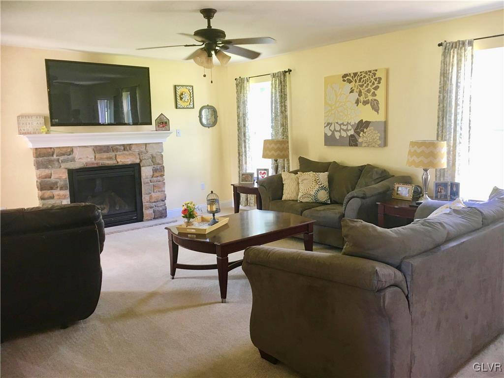146 Fox Ridge Nazareth, PA 18064 - Photo 13 of 24 a living room with furniture a flat screen tv and a fireplace