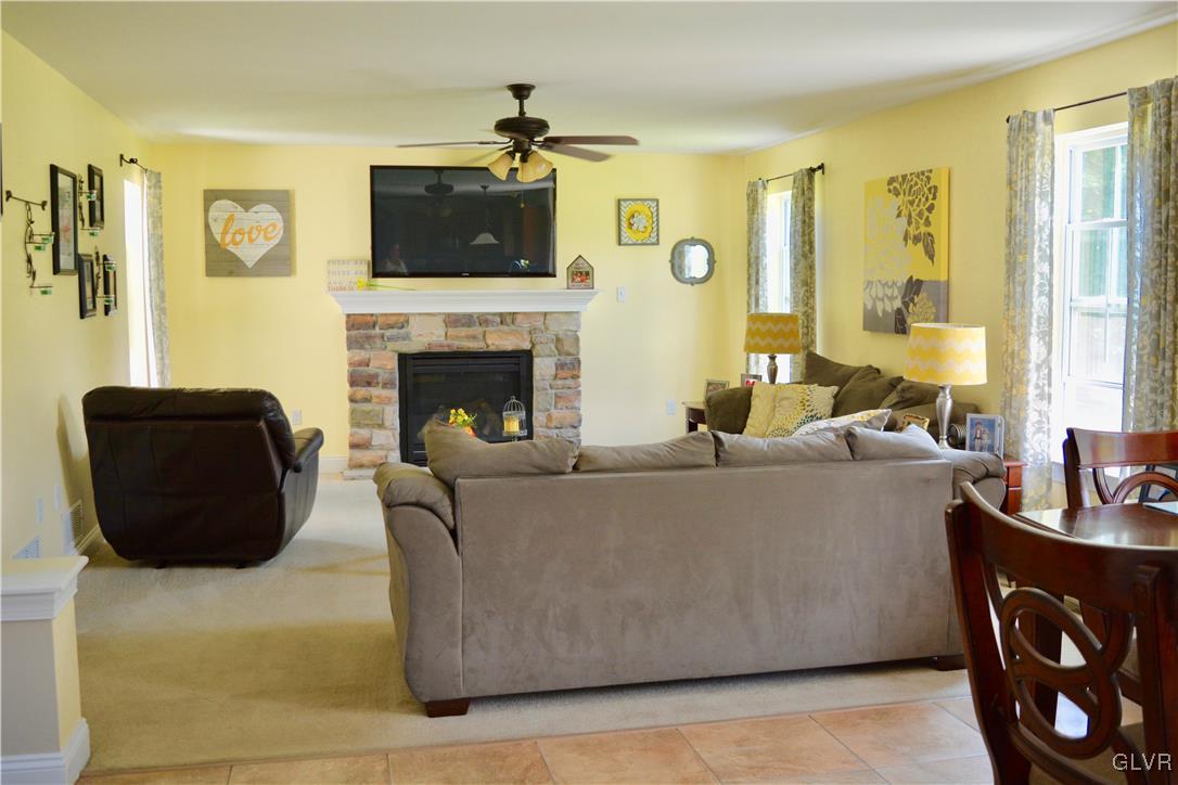 146 Fox Ridge Nazareth, PA 18064 - Photo 14 of 24 a living room with furniture a fireplace and a flat screen tv