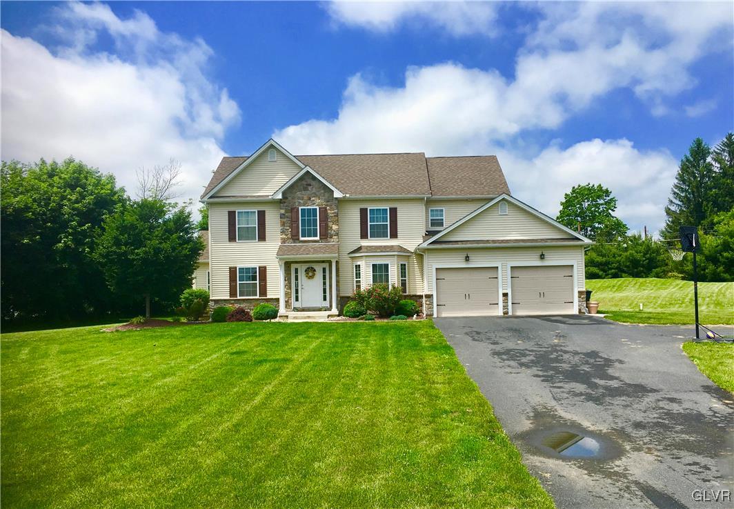 146 Fox Ridge Nazareth, PA 18064 - Photo 2 of 24 a front view of a house with a yard and garage