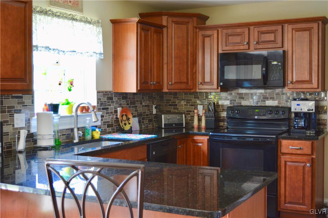 146 Fox Ridge Nazareth, PA 18064 - Photo 6 of 24 a kitchen with a stove a sink and a microwave